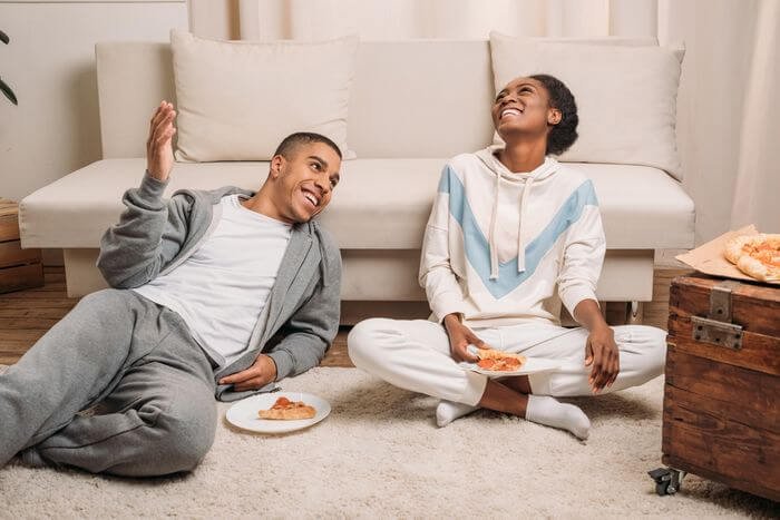 African couple eating pizza